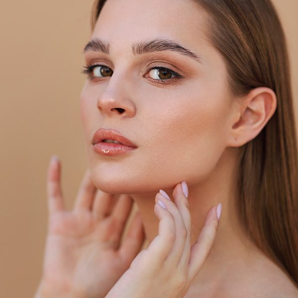 portrait-beautiful-young-woman-against-beige-background