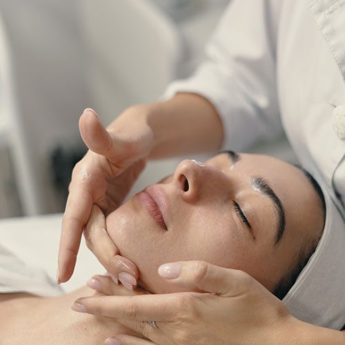 young-woman-lies-with-closed-eyes-cosmetologist-making-procedure young-woman-lies-with-closed-eyes-cosmetologist-making-procedure
